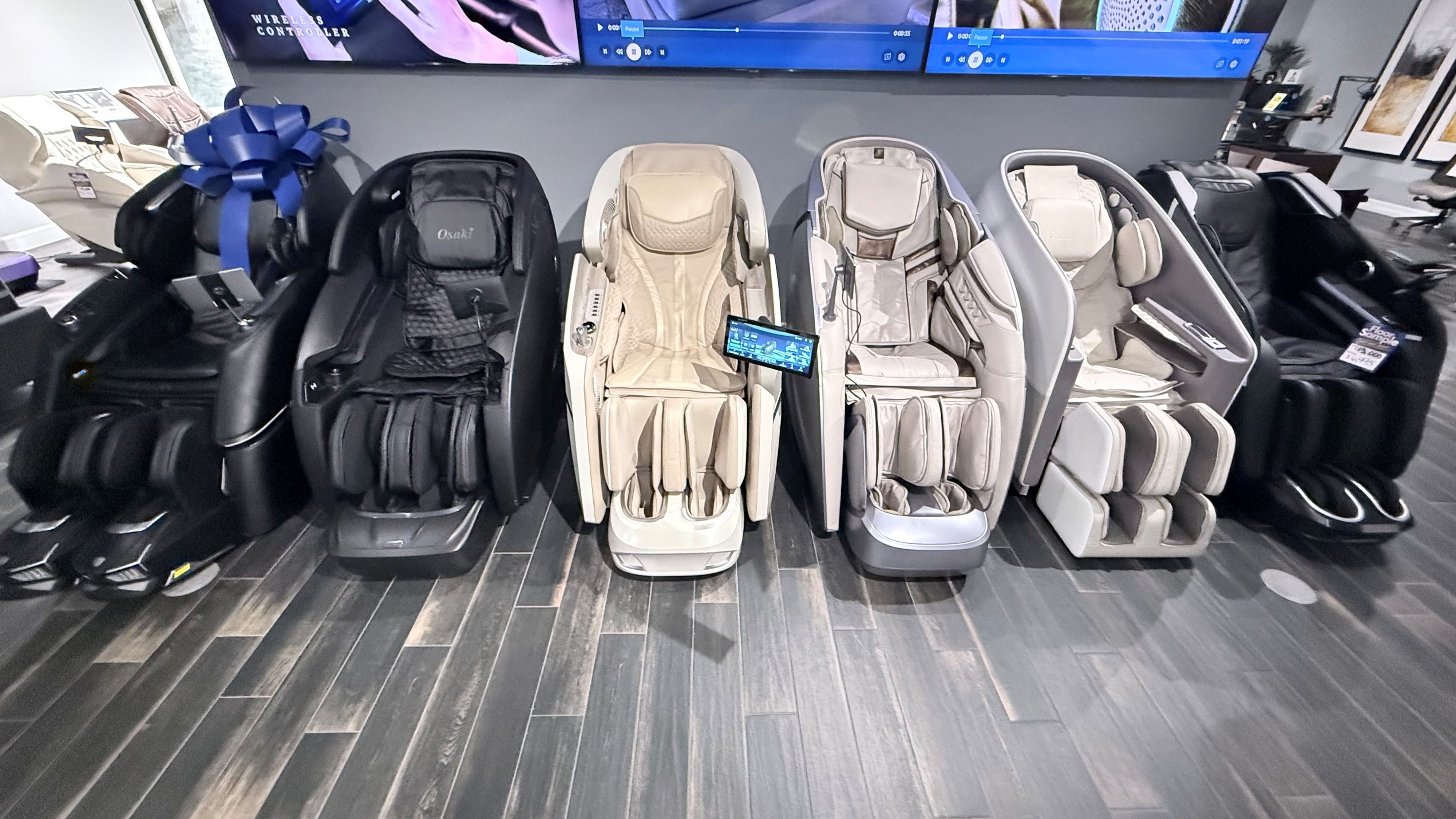 Orlando massage chairs in front of a gray wall and tvs